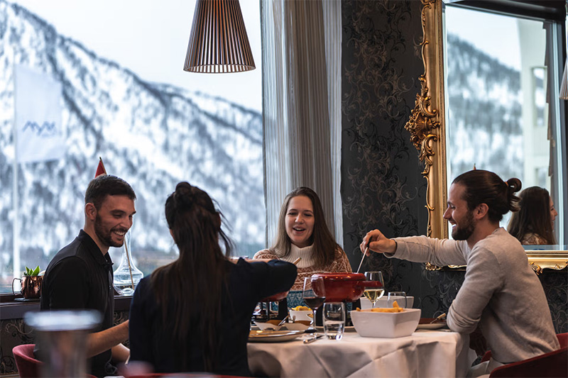 Group sat around a fondue at Restaurant Nuten, Myrkdalen Hotel
