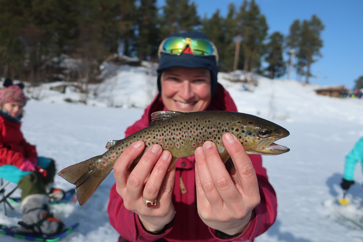 Person holds their freshly caught fish © Norway Home of Skiing