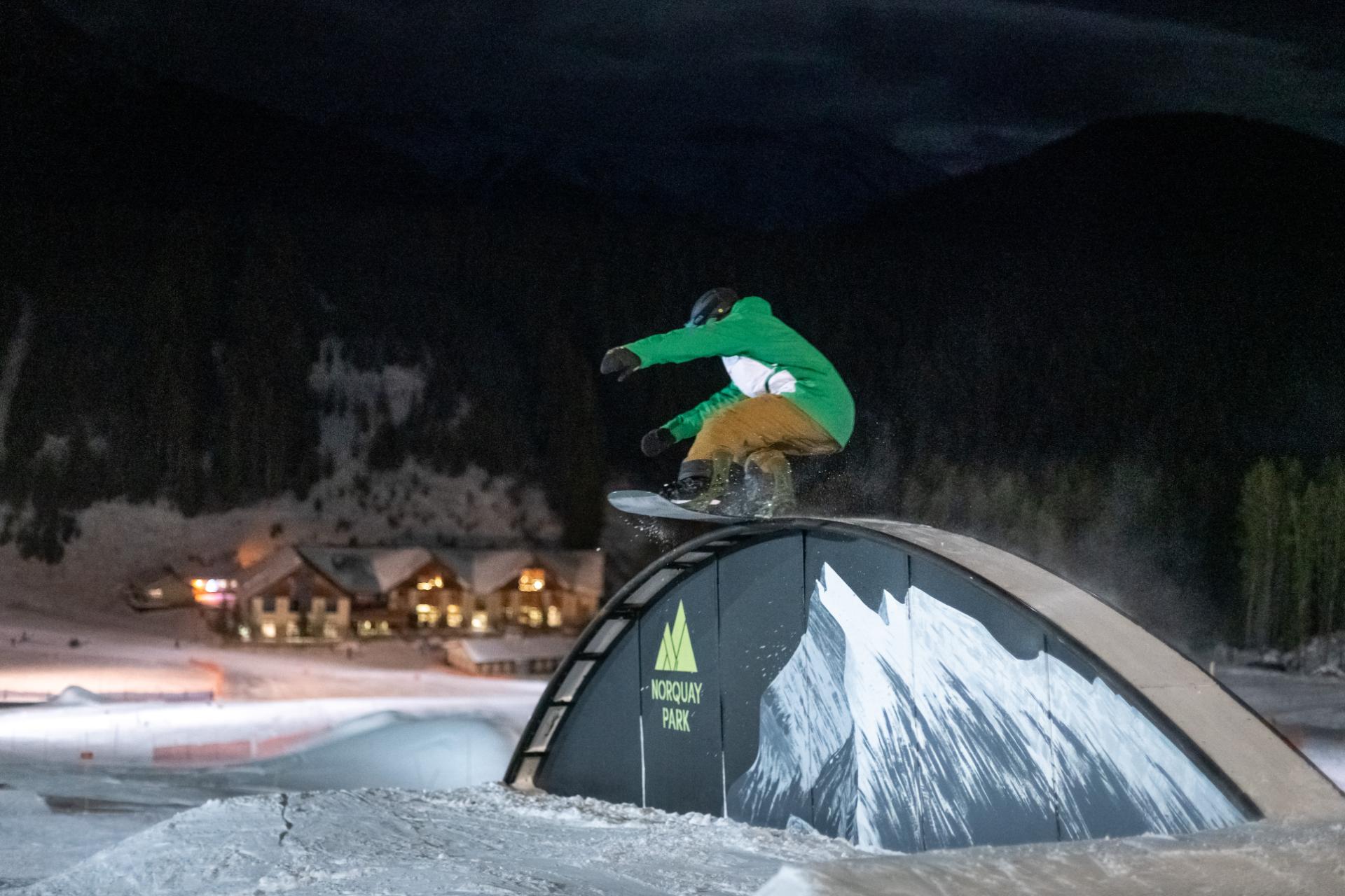 Snowboarder night skiing in Mt. Norquay's snow park Snowboarder night skiing in Mt. Norquay's snow park