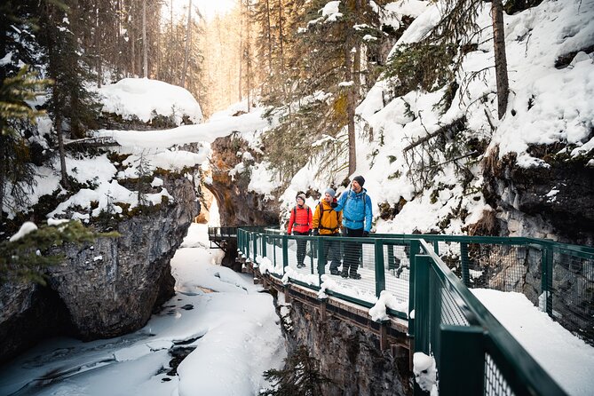 People walking along suspended catwalks and past frozen waterfalls in Johnston Canyon People walking along suspended catwalks and past frozen waterfalls in Johnston Canyon